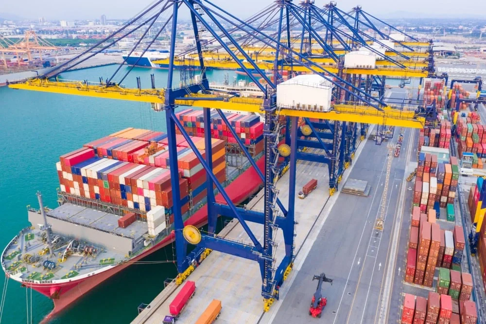 Container vessel loading beneath gantry cranes at an international seaport